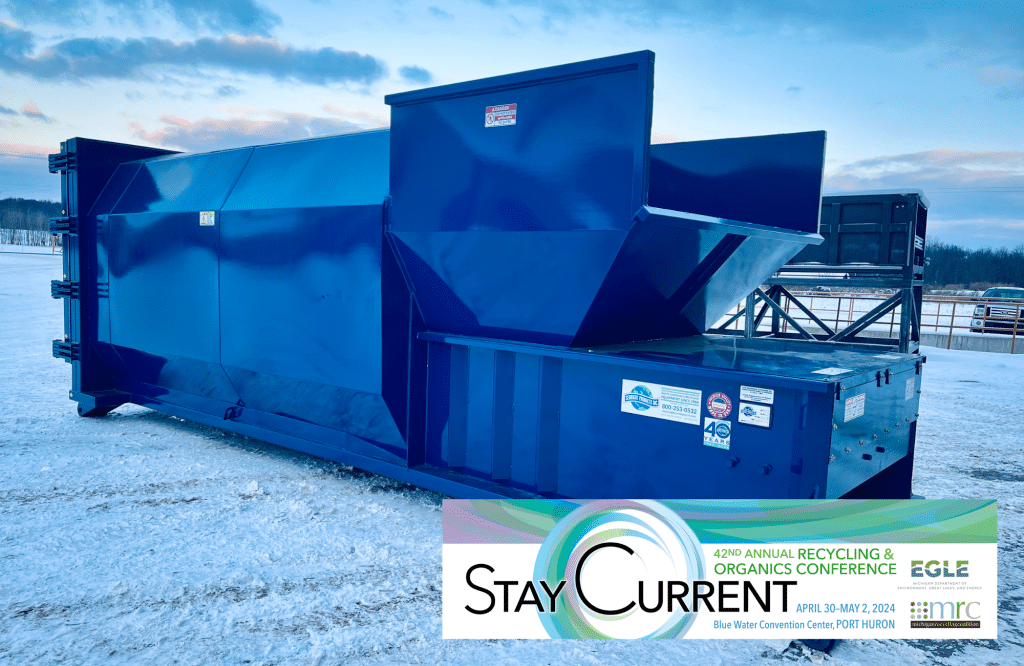 Blue compactor in the snow at the waste management event, MRC Annual Conference.